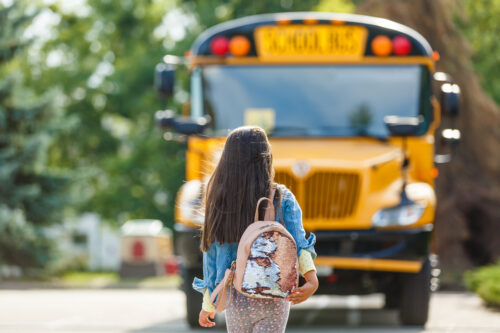 student walking towards a school bus