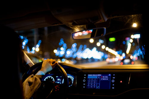 A woman driving a car at night